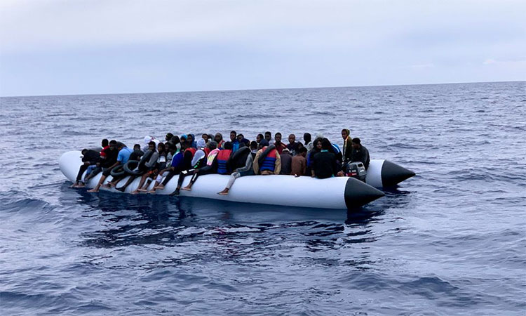 Migrants are seen on a rubber dinghy as Libyan Coast Guards arrive to rescue them in the Mediterranean Sea, off the coast of Libya. Reuters