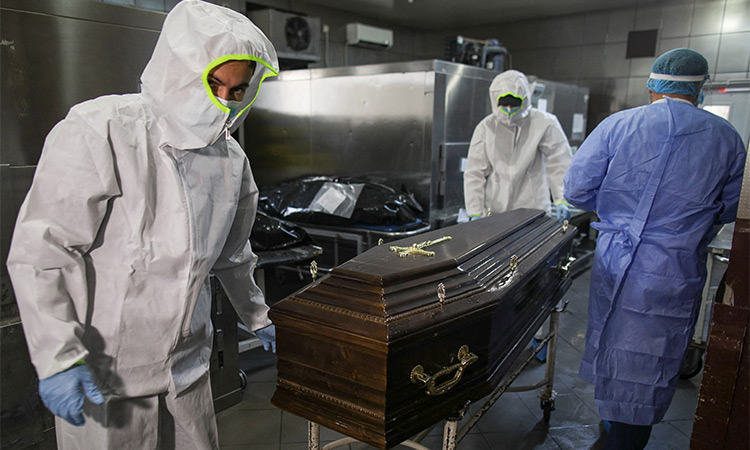 A coffin is being shifted from a hospital to a mortury in New York.