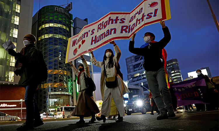 Participants hold a placard at a march to call for gender equality and protest against gender discrimination on International Women's Day in Tokyo. File/Reuters