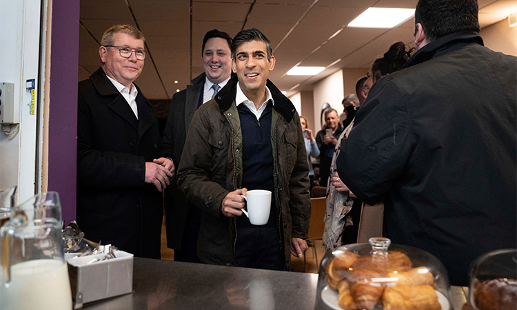 Britain’s Prime Minister Rishi Sunak, centre, meets staff and local party members at Firthmoor Community Centre during a visit to Darlington, County Durham.  File/Associated Press