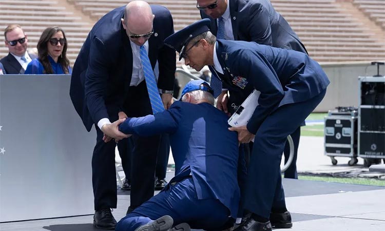 President Joe Biden is helped up after falling during the graduation ceremony at the U.S. Air Force Academy in El Paso County, Colorado. AFP