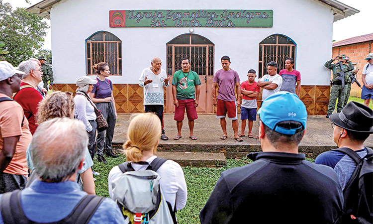 A group of researchers and scientists are greeted by the local community during a visit to the Sustainable Development Reserve Puranga-Conquista to the Lower Rio Negro Mosaic, Amazonas State, Brazil, on July 9.  Agence France-Presse