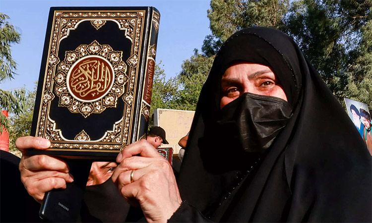 A woman holds a copy of the Holy Quran during a protest in Stockholm, Sweden. Reuters
