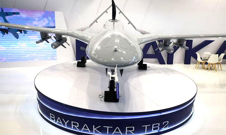 Bayraktar TB2 drone stands near the logo of Baykar Turkish defence company inside a hall of 30th international Defence Industry Exhibition in Kielce, Poland. Reuters