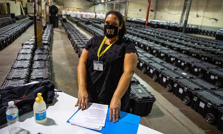 Poll worker Angela Steele mans the check-in desk near rows of empty ballot boxes at the Allegheny County Election Warehouse in Pennsylvania, US. Reuters