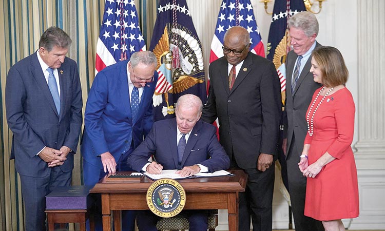 President Joe Biden signs the Inflation Reduction Act of 2022 into law during a ceremony in the State Dining Room of the White House in Washington, DC.  Tribune News Service