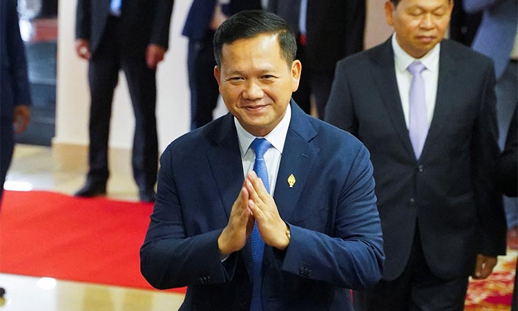 Hun Manet, nominee for Cambodia’s prime minister, greets as he registers at the National Assembly on the day that parliament votes to confirm the country’s next prime minister, in Phnom Penh, Cambodia, on Tuesday. Reuters