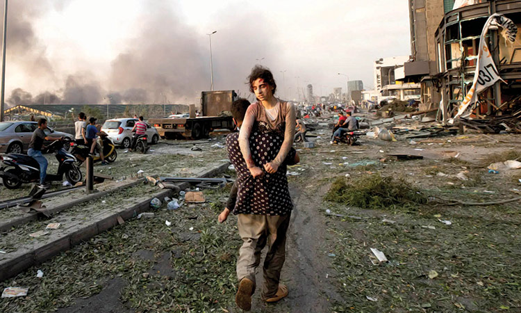 People evacuate the wounded after a massive explosion in Beirut, Lebanon.     File/Associated Press