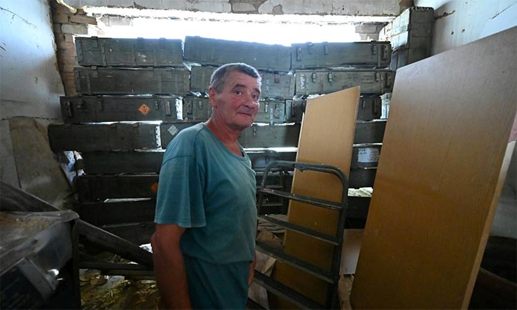 Oleksandr Kokovych, 58, shows AFP his partially destroyed house in the village of Mala Komyshuvakha.