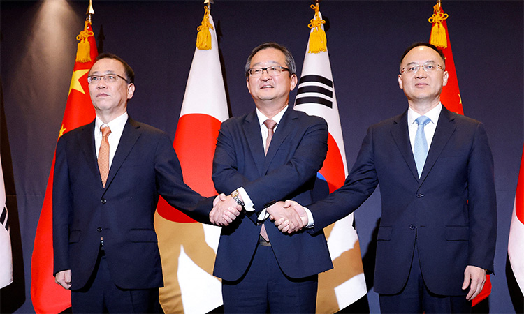 South Korea's deputy foreign minister for political affairs, Chung Byung-won, Japan's Senior Deputy Minister for Foreign Affairs, Funakoshi Takehiro, and China's Assistant Foreign Minister, Nong Rong, pose for photographs during their meeting in Seoul, South Korea. Reuters
