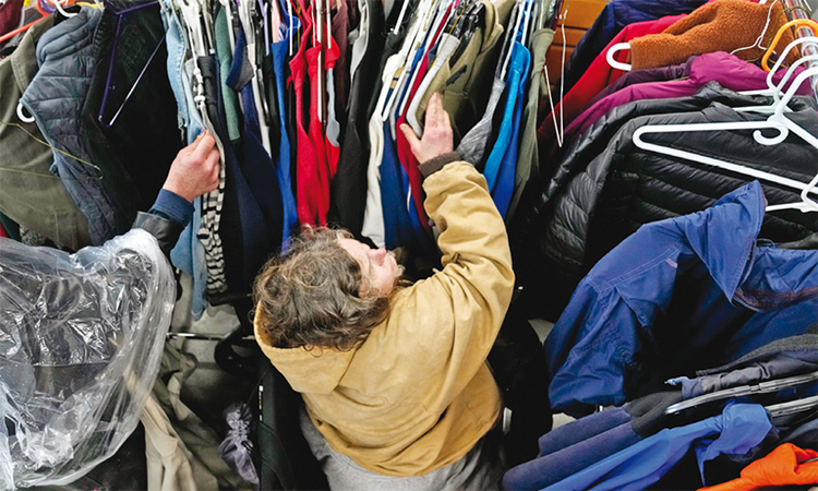 People look through winter garments at a donation centre in Portland, Oregon. AP