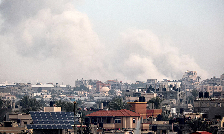 A picture taken from Rafah shows smoke billowing over Khan Yunis in the southern Gaza Strip during Israeli bombardment. AFP