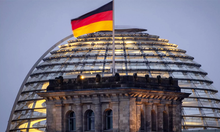 The German national flag waves on top of the Reichtstag building in Berlin. The Reichstag is the home of the German parliament Bundestag. AP