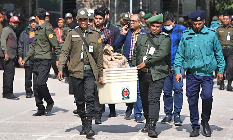 Bangladeshi security personnel carry polling materials outside a distribution centre in Dhaka. AFP