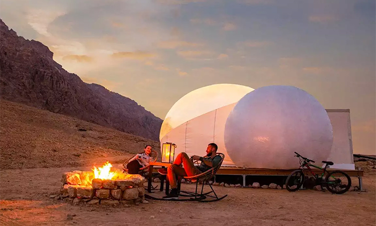 A desert canvas illuminated by the sun, where campfires and luxury intertwine in tranquil harmony.