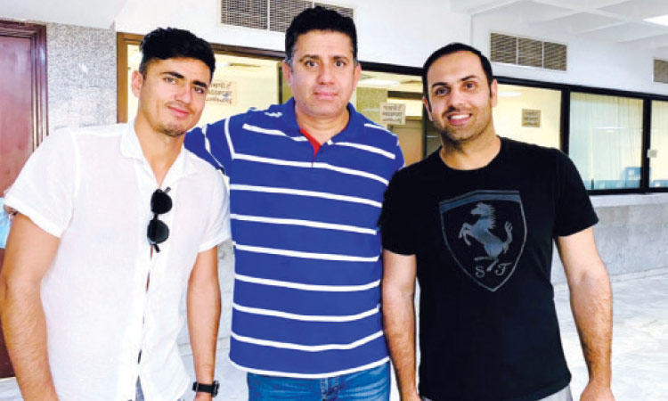 Amaan Haider (centre) flanked by Afghanistan’s cricketers Mohammad Nabi (right) and Mujeeb-ur-Rahman.