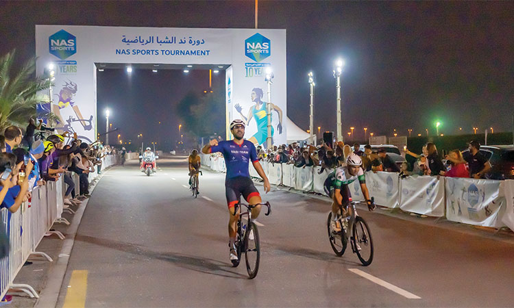 Tunisian rider Nousri Ali reacts after crossing the finish line to win the Men’s Open final at the Nad Al Sheba Cycling Championship.