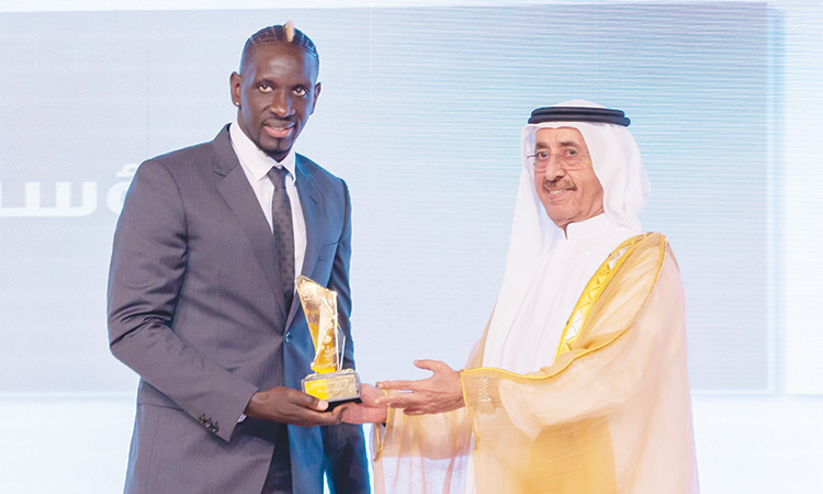 Mamadou Sakho receives the Sports Footprint award from Sheikh Hasher Bin Maktoum Bin Juma Al Maktoum during a ceremony in Dubai.