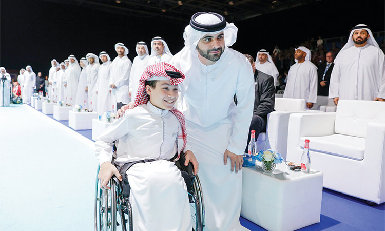 Sheikh Mansoor poses for a picture with a participant during the opening ceremony of the IWBF Wheelchair Basketball World Championships at the Dubai World Trade Centre on Friday.