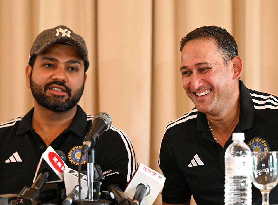 India's chief cricket selector Ajit Agarkar (right) smiles as team captain Rohit Sharma watches during a press conference in Kandy on Tuesday. AFP