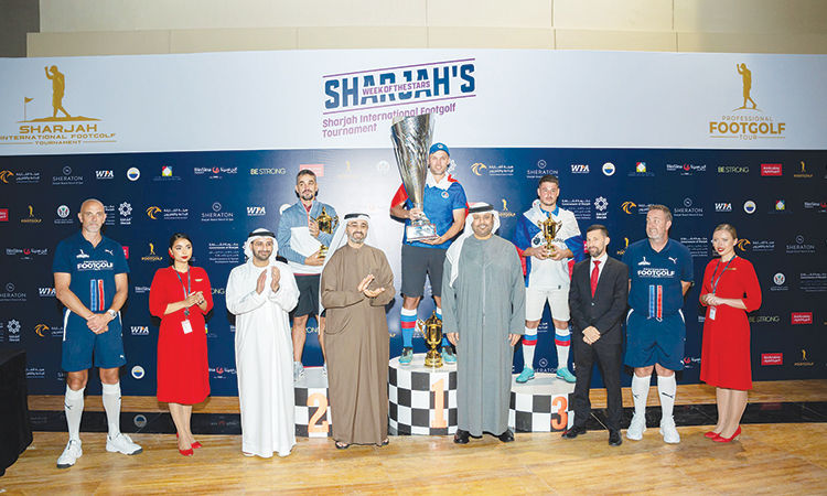 Winners pose with their trophies along with officials during the presentation ceremony.