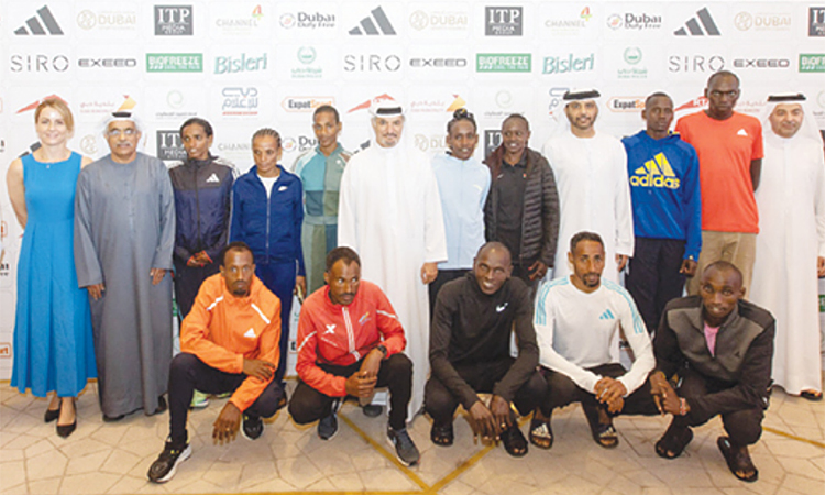 Saeed Hareb and Dr Mohammed Al Murr, with elite runners and other dignitaries, pose for a picture after the press conference.