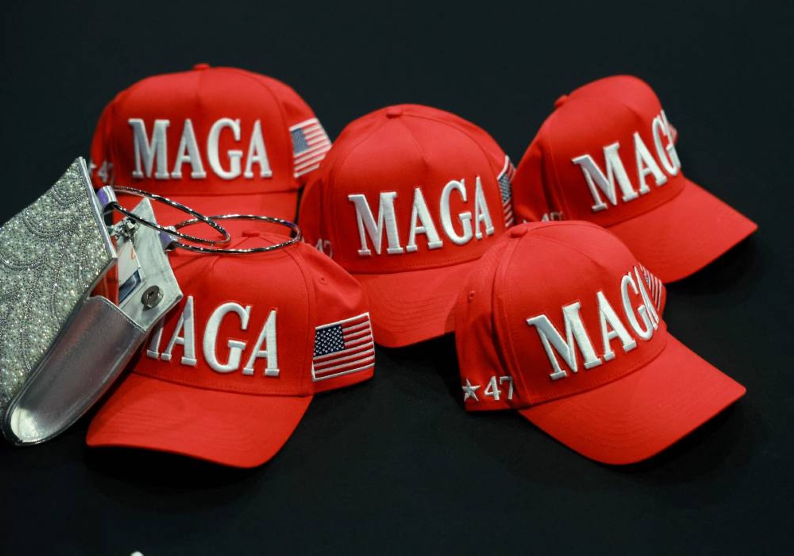 MAGA hats sit on a table at the Palm Beach County Convention Center in West Palm Beach, Florida. File/AFP