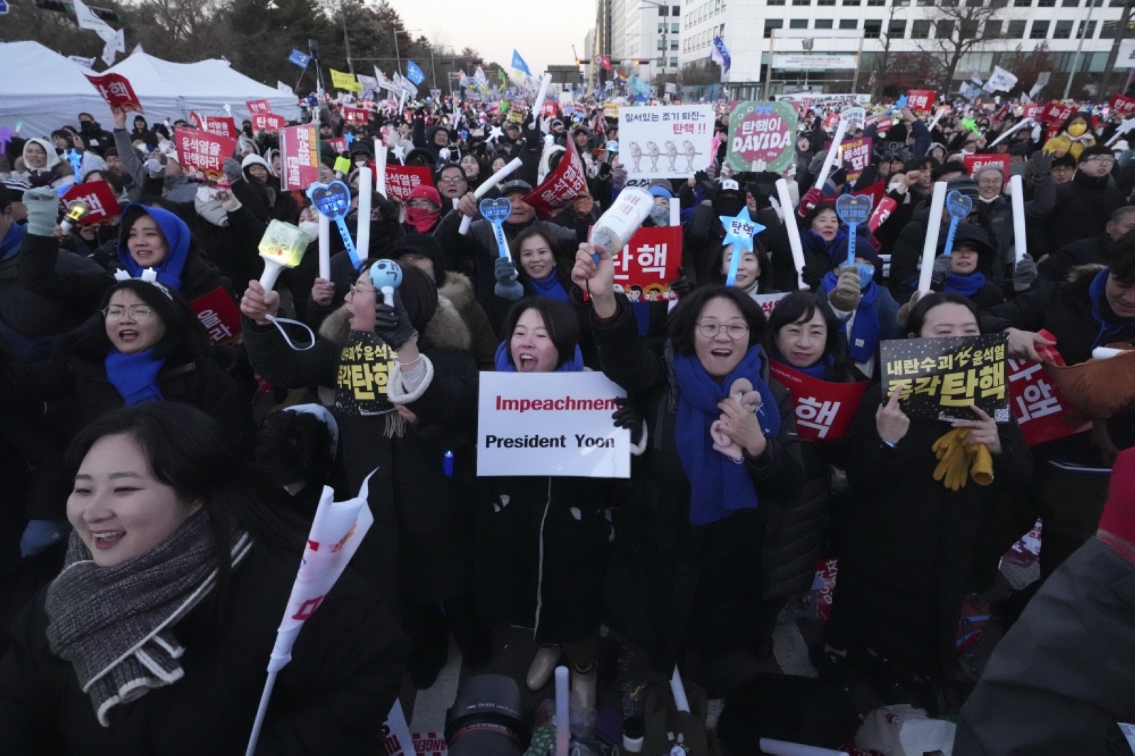 Jubilant South Koreans celebrate President Yoon’s impeachment in freezing Seoul