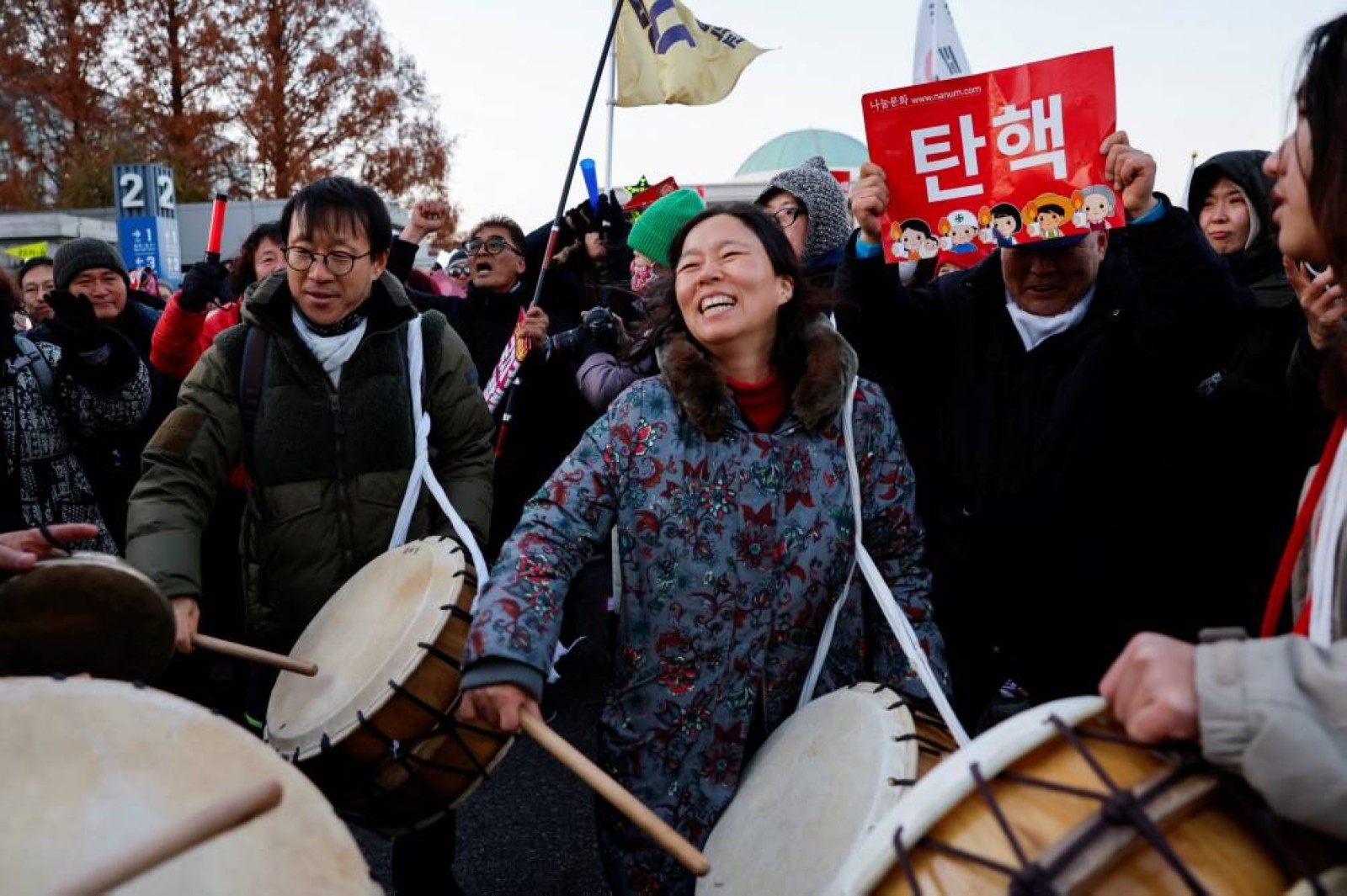 Jubilant South Koreans celebrate President Yoon’s impeachment in freezing Seoul