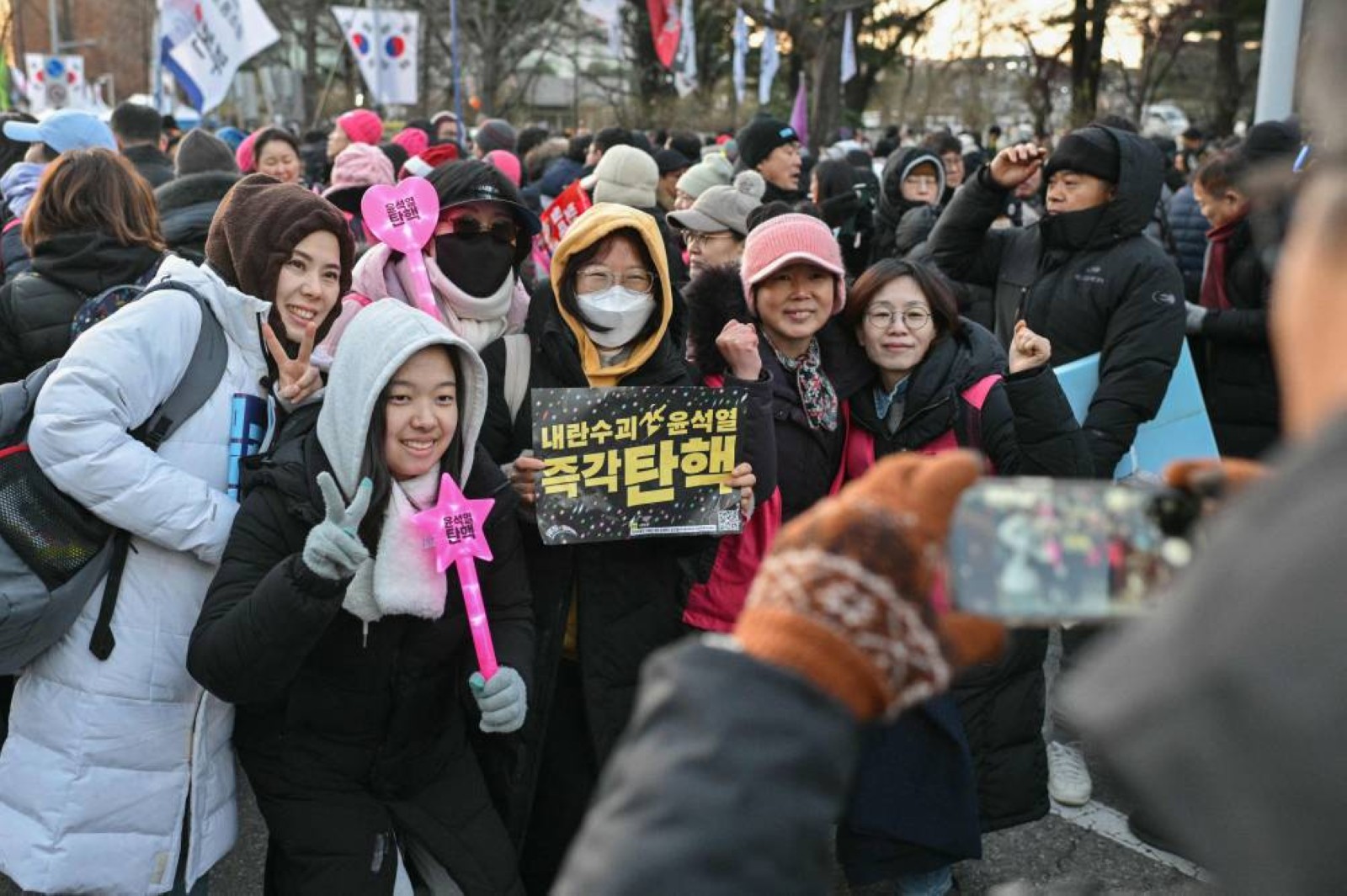 Jubilant South Koreans celebrate President Yoon’s impeachment in freezing Seoul