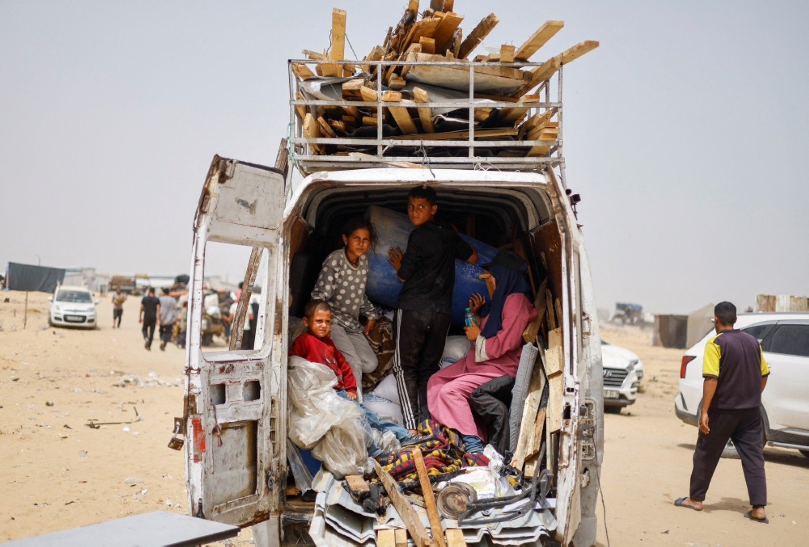 A displaced Palestinian family ride in a vehicle loaded with their belongings as they prepare to flee Rafah following a Israeli strike nearby. File/Reuters