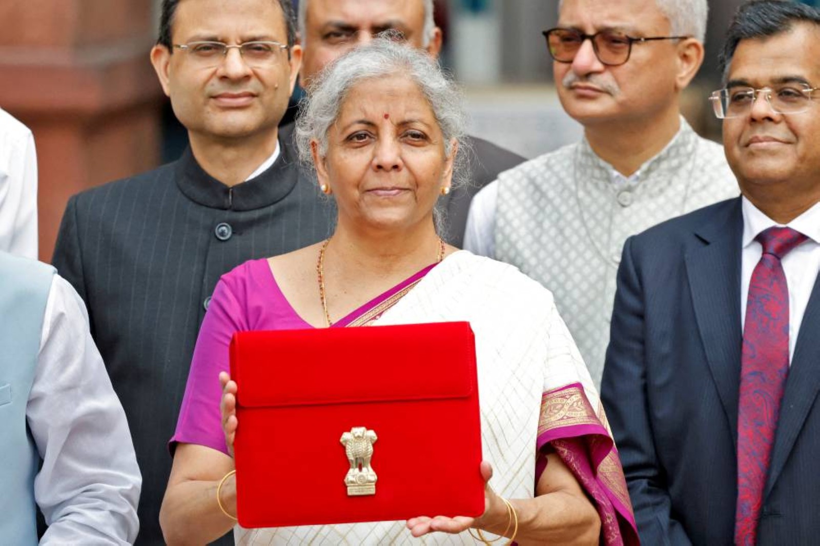 India's Finance Minister Nirmala Sitharaman holds up a folder with the Government of India's logo as she leaves her office to present the union budget in the parliament in New Delhi, India. Reuters
