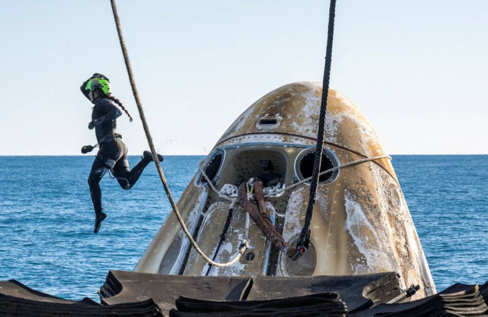 Smiles, thumbs ups and playful dolphins mark stranded Nasa astronauts' return to Earth
