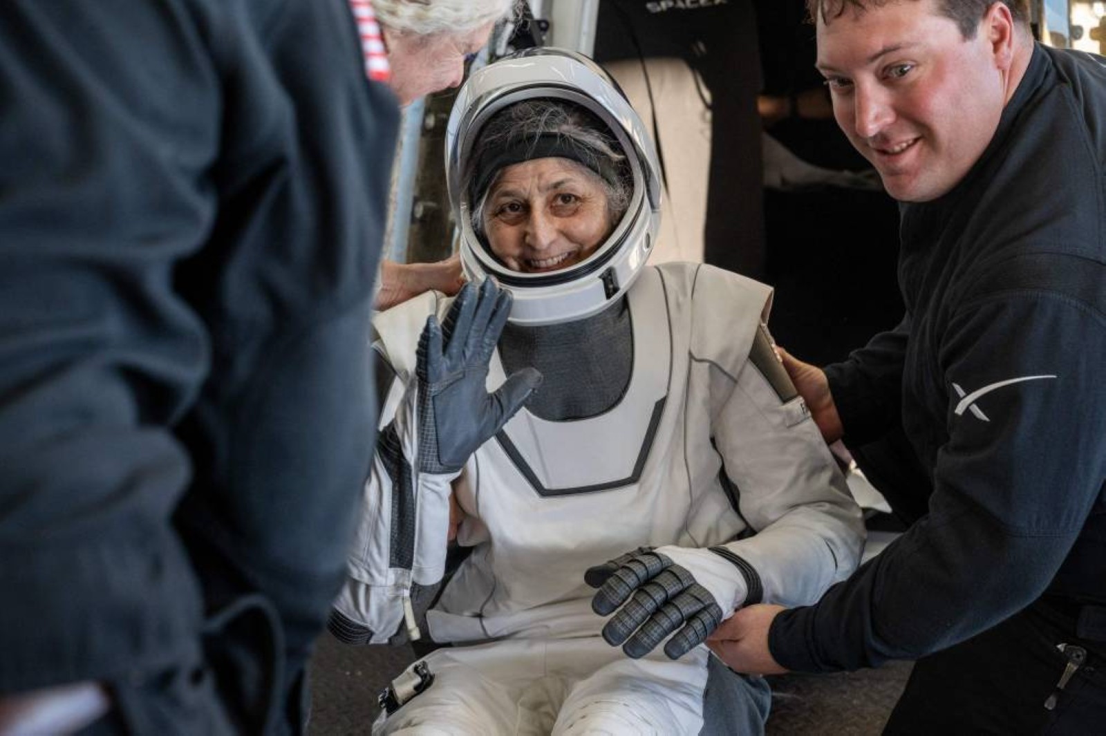 Smiles, thumbs ups and playful dolphins mark stranded Nasa astronauts' return to Earth