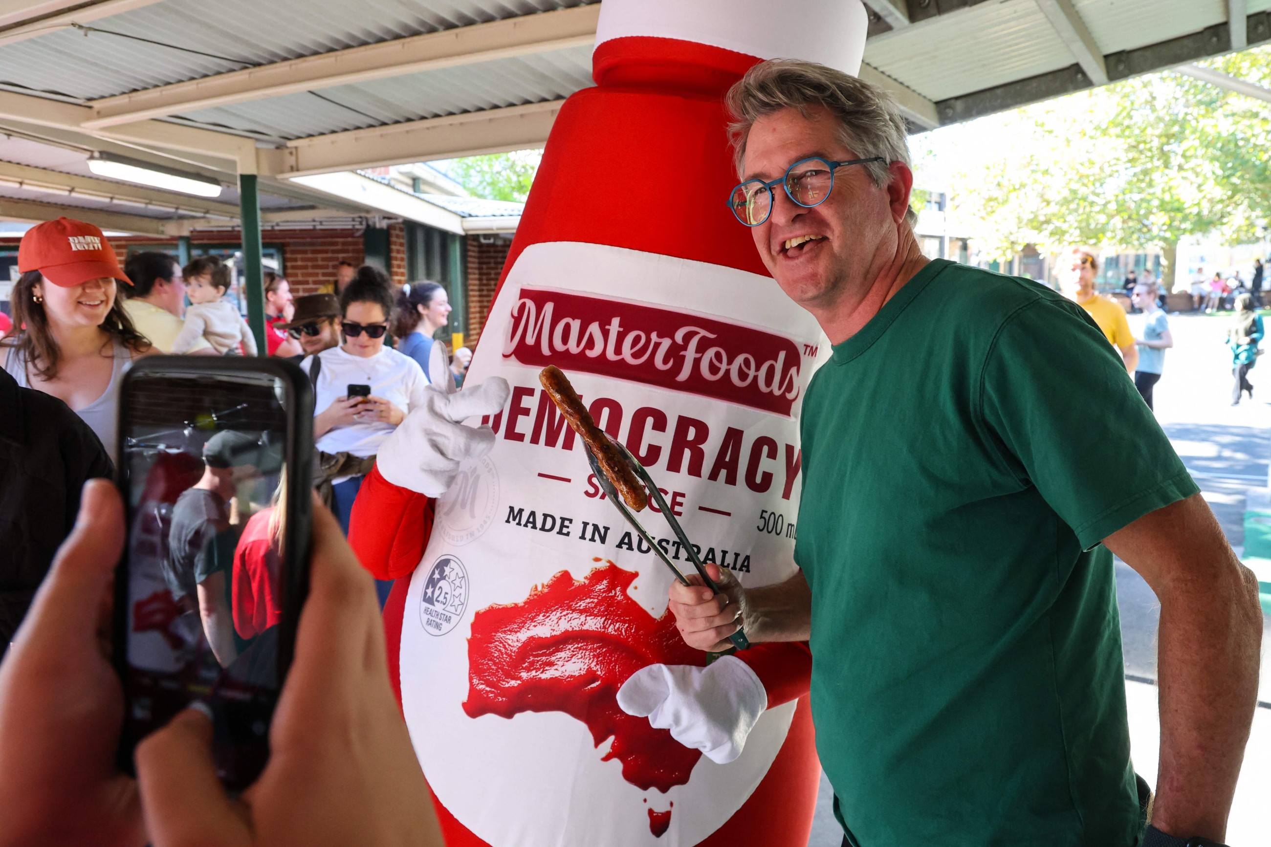 Australians sizzle on election day with 'democracy sausages' and 'budgy smugglers'