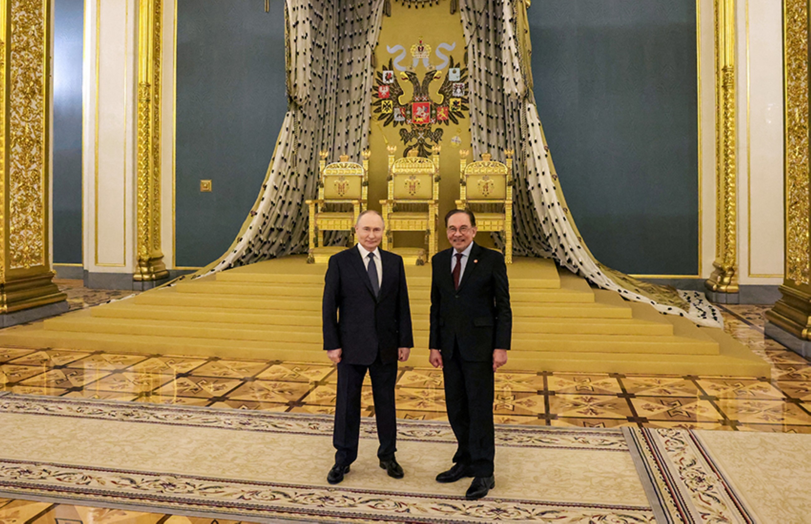 Vladimir Putin and Anwar Ibrahim pose for a picture following their talks at St Andrew's Hall in the Kremlin in Moscow. Reuters 