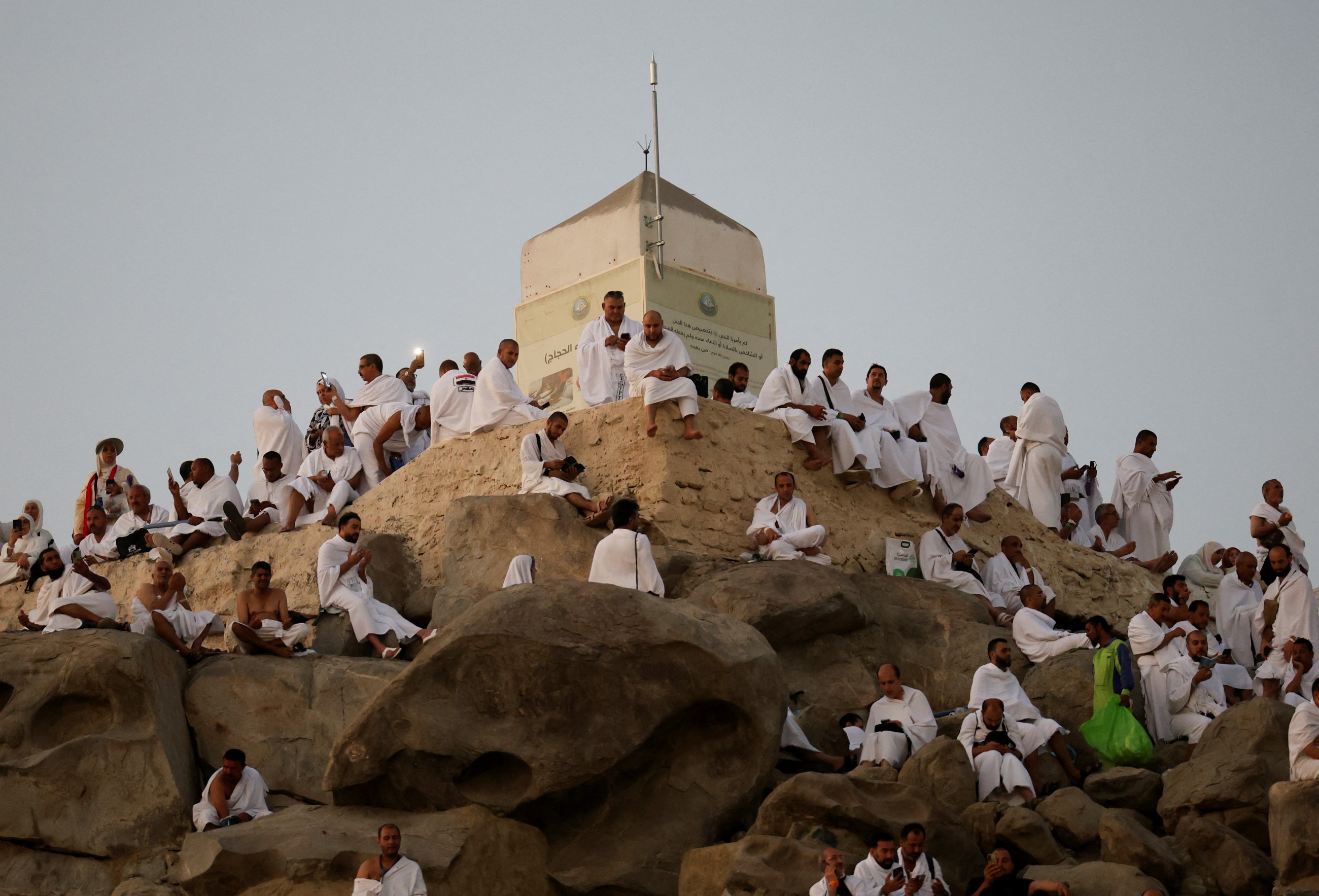 Muslim pilgrims pray at Mount Arafat in Hajj apex