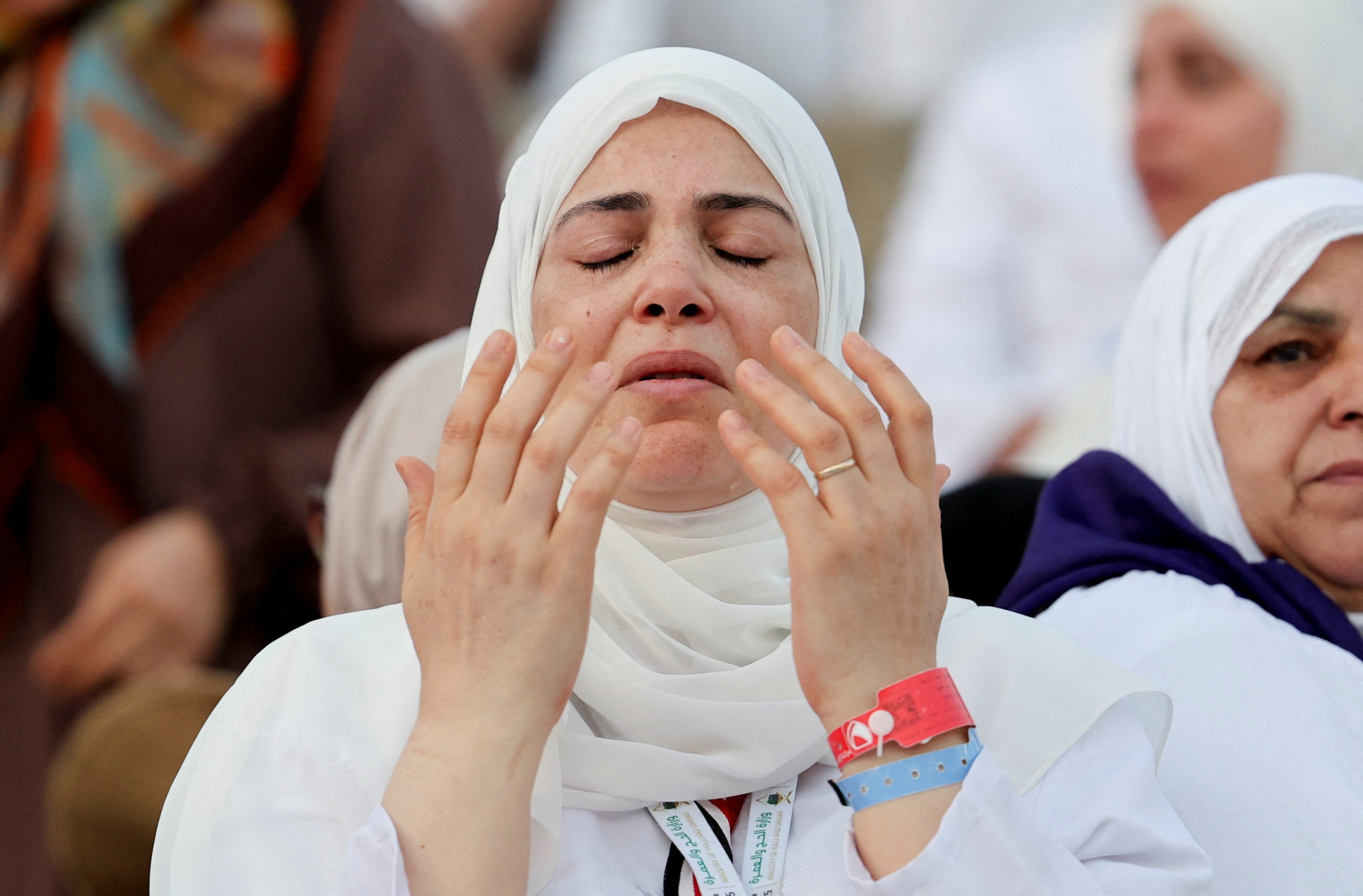 Muslim pilgrims pray at Mount Arafat in Hajj apex