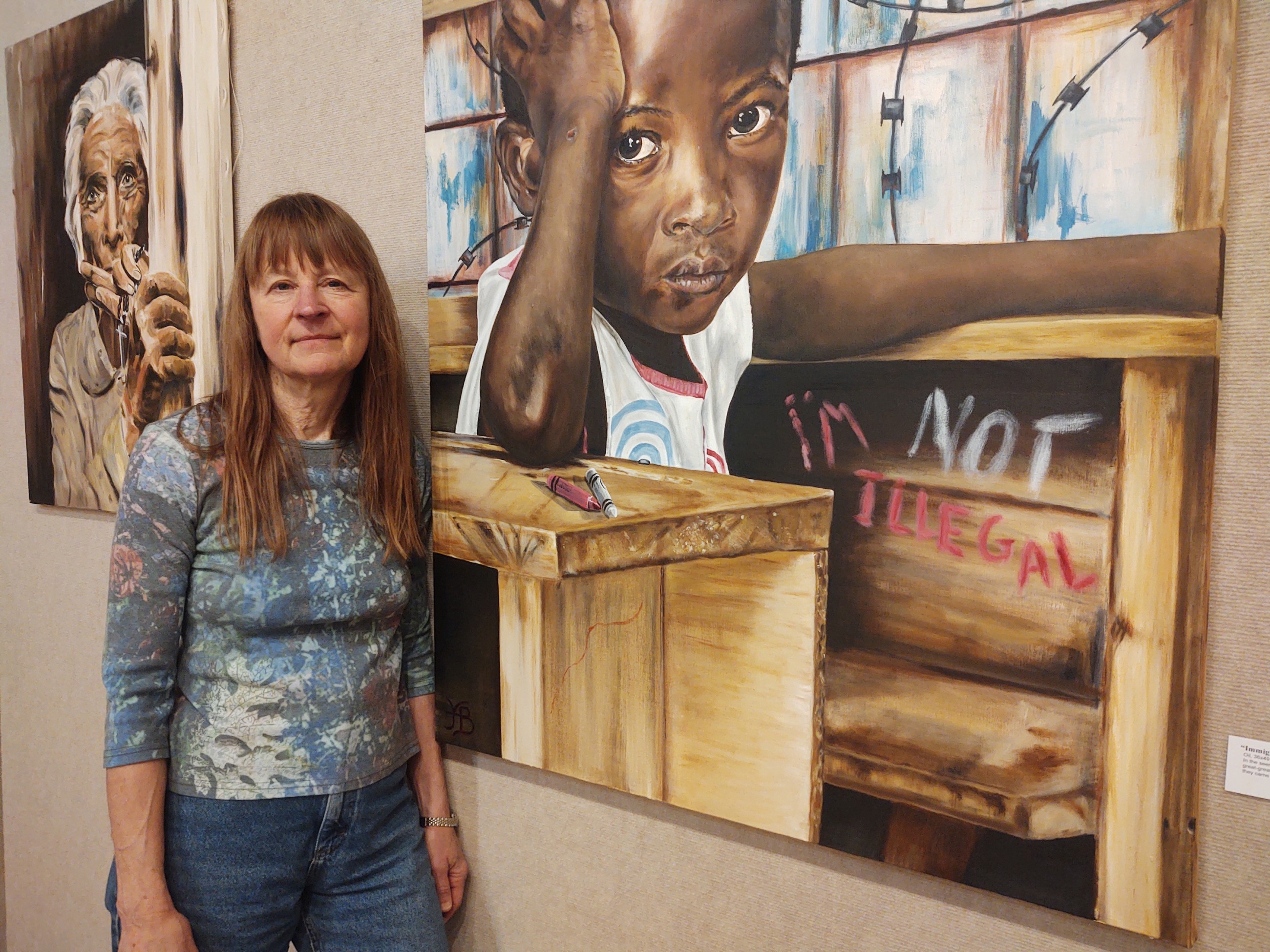 An artist paints portraits of refugees and immigrants