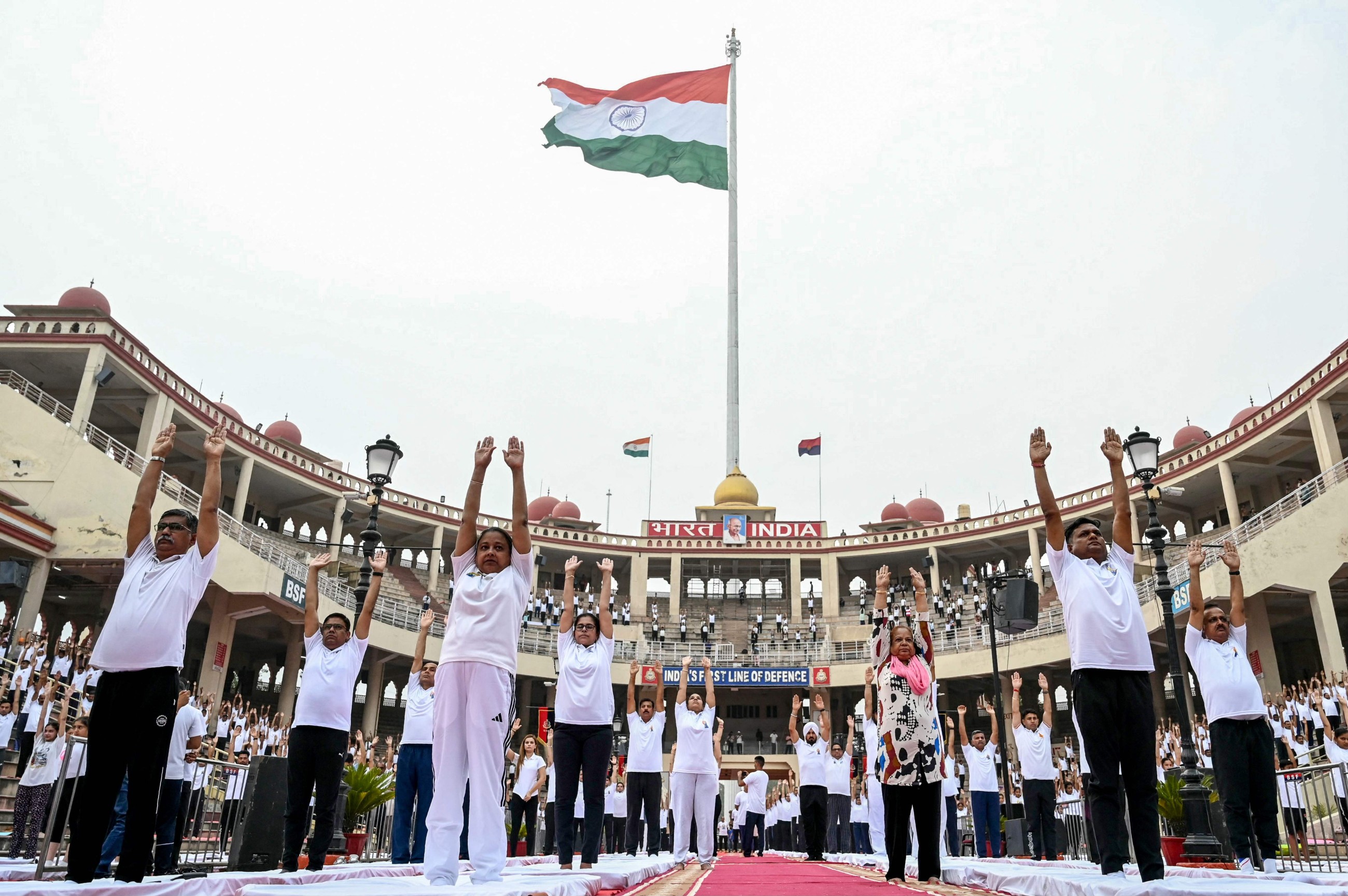 Tens of thousands of enthusiasts stretch, breathe and balance to mark International Day of Yoga