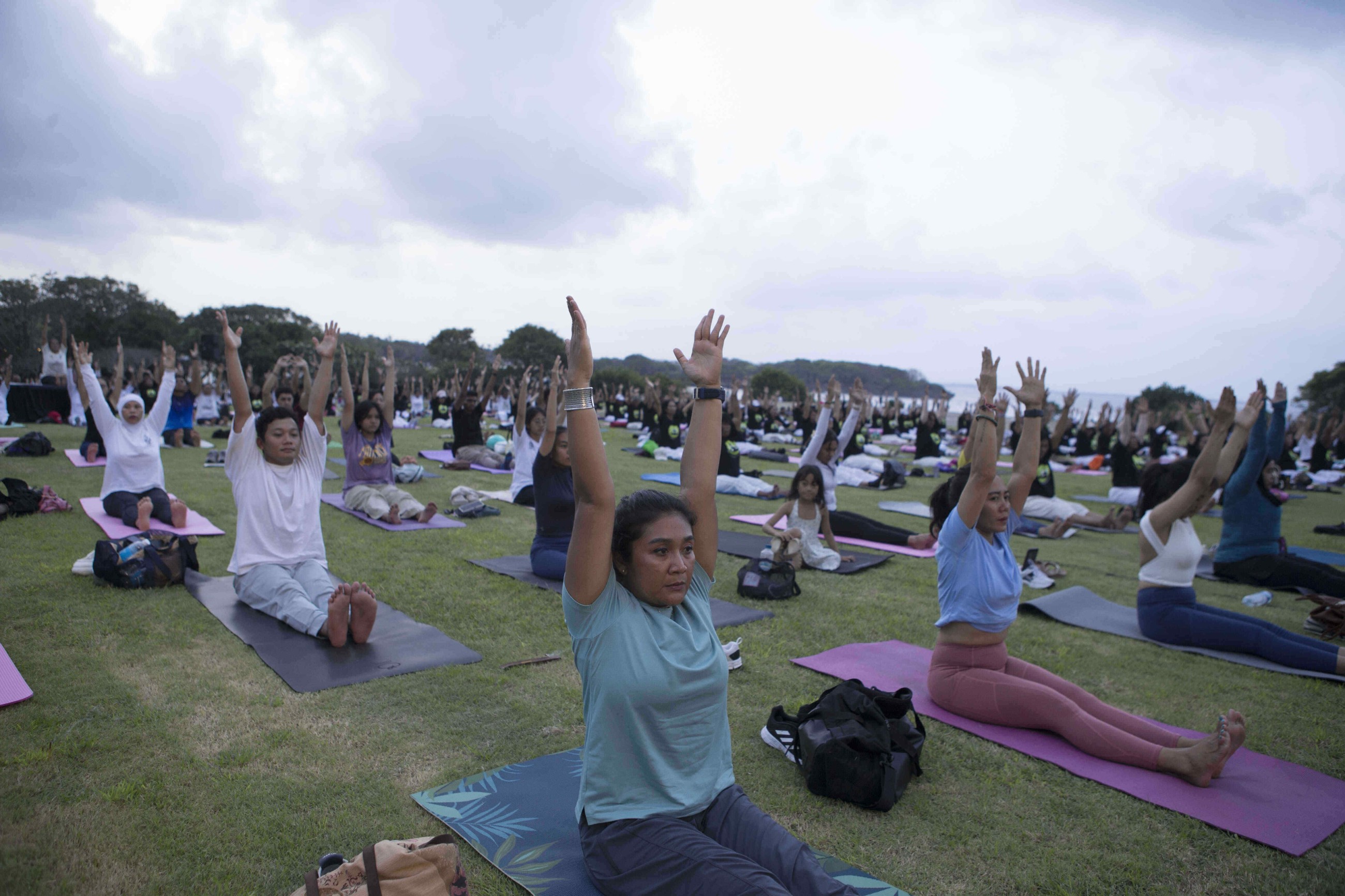 Tens of thousands of enthusiasts stretch, breathe and balance to mark International Day of Yoga