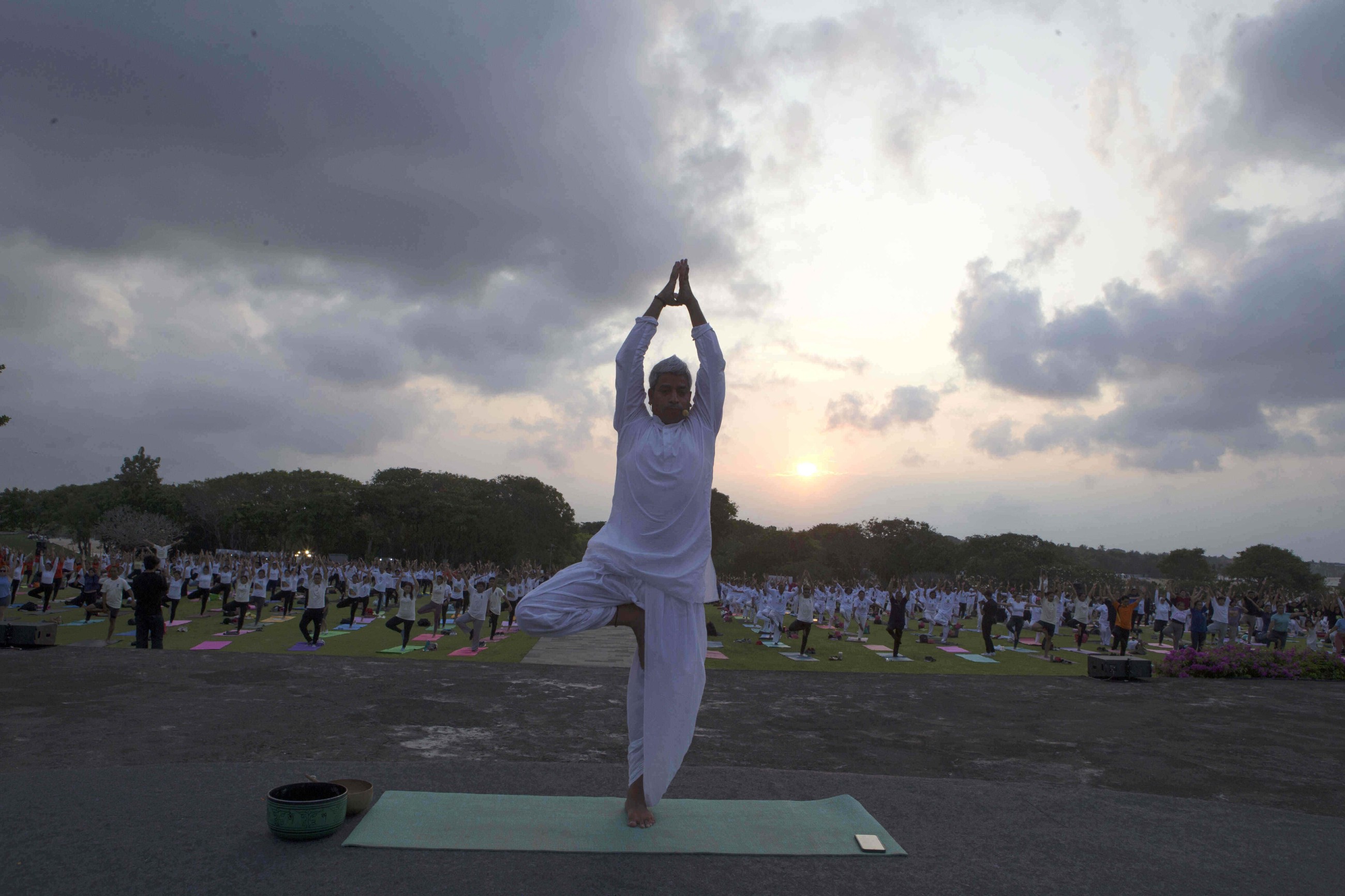 Tens of thousands of enthusiasts stretch, breathe and balance to mark International Day of Yoga