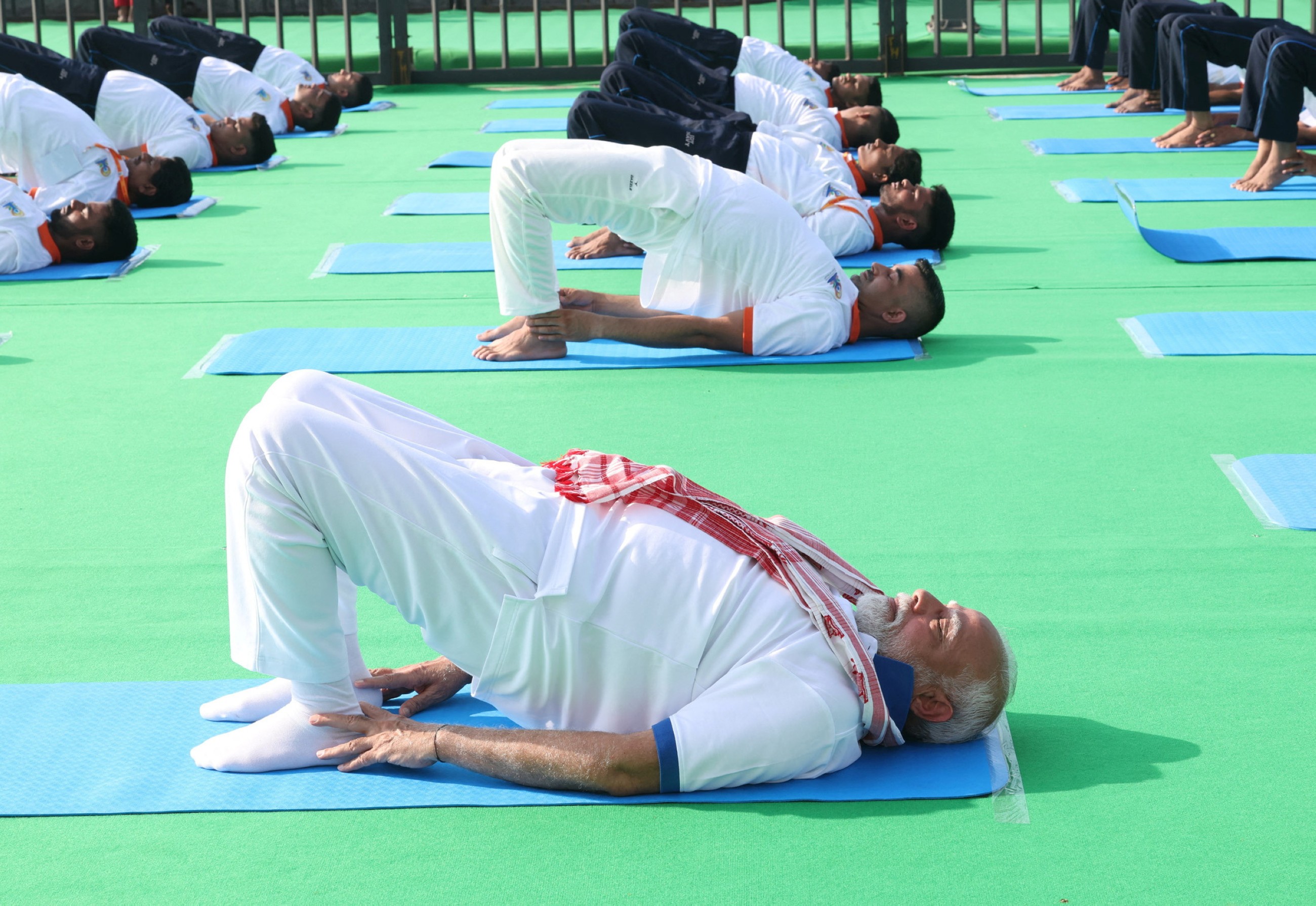 Tens of thousands of enthusiasts stretch, breathe and balance to mark International Day of Yoga