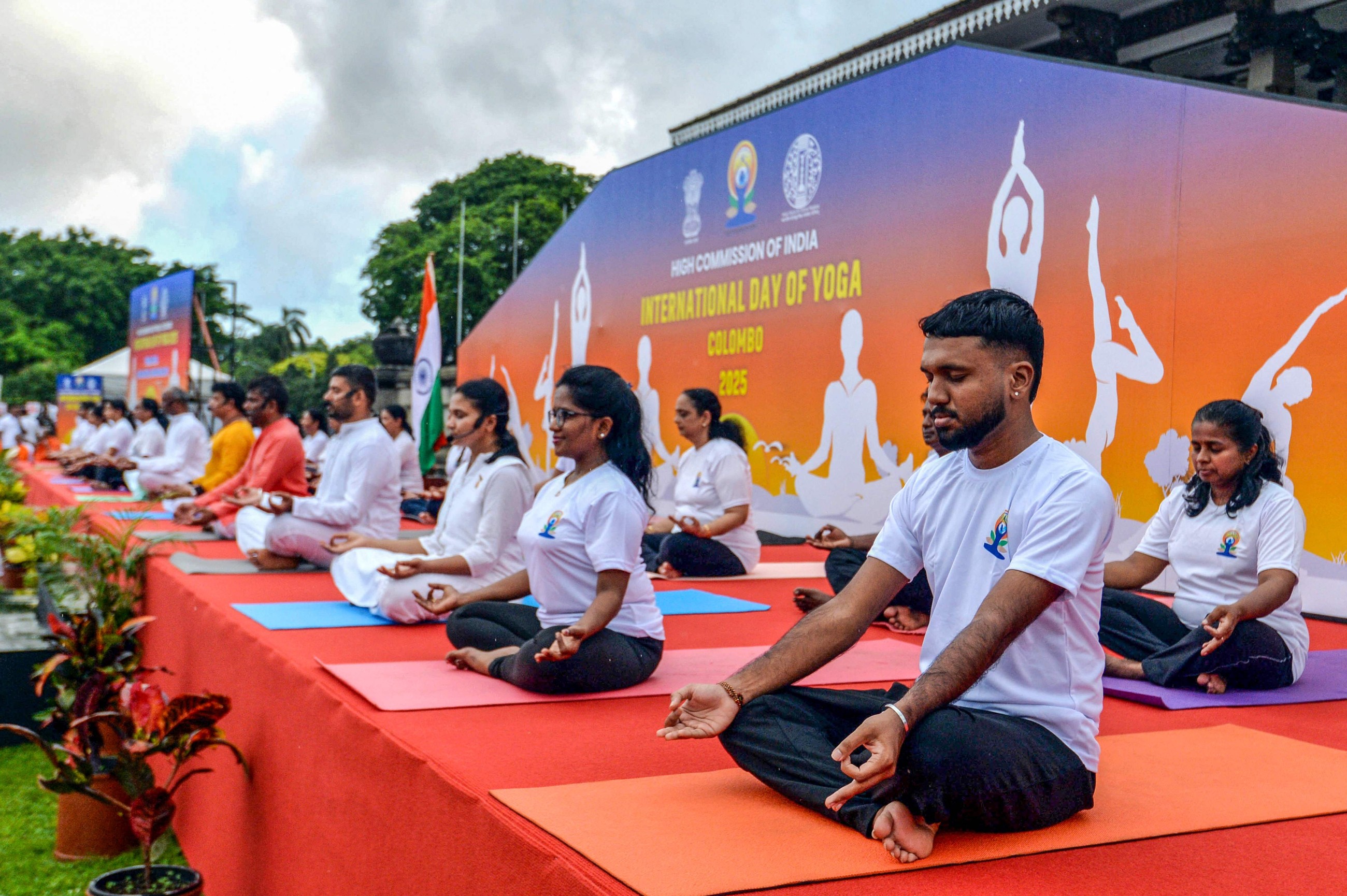 Tens of thousands of enthusiasts stretch, breathe and balance to mark International Day of Yoga