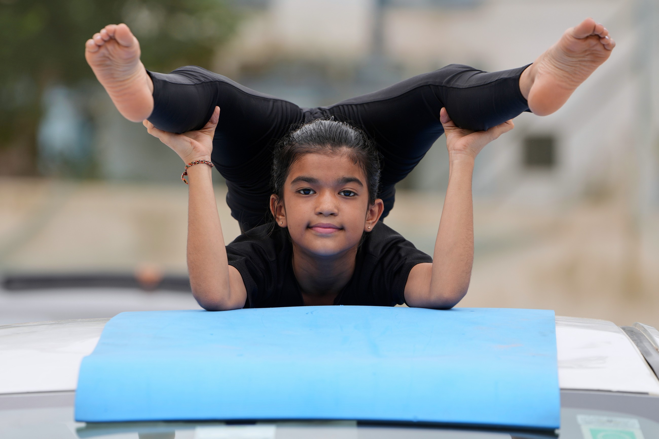 Tens of thousands of enthusiasts stretch, breathe and balance to mark International Day of Yoga