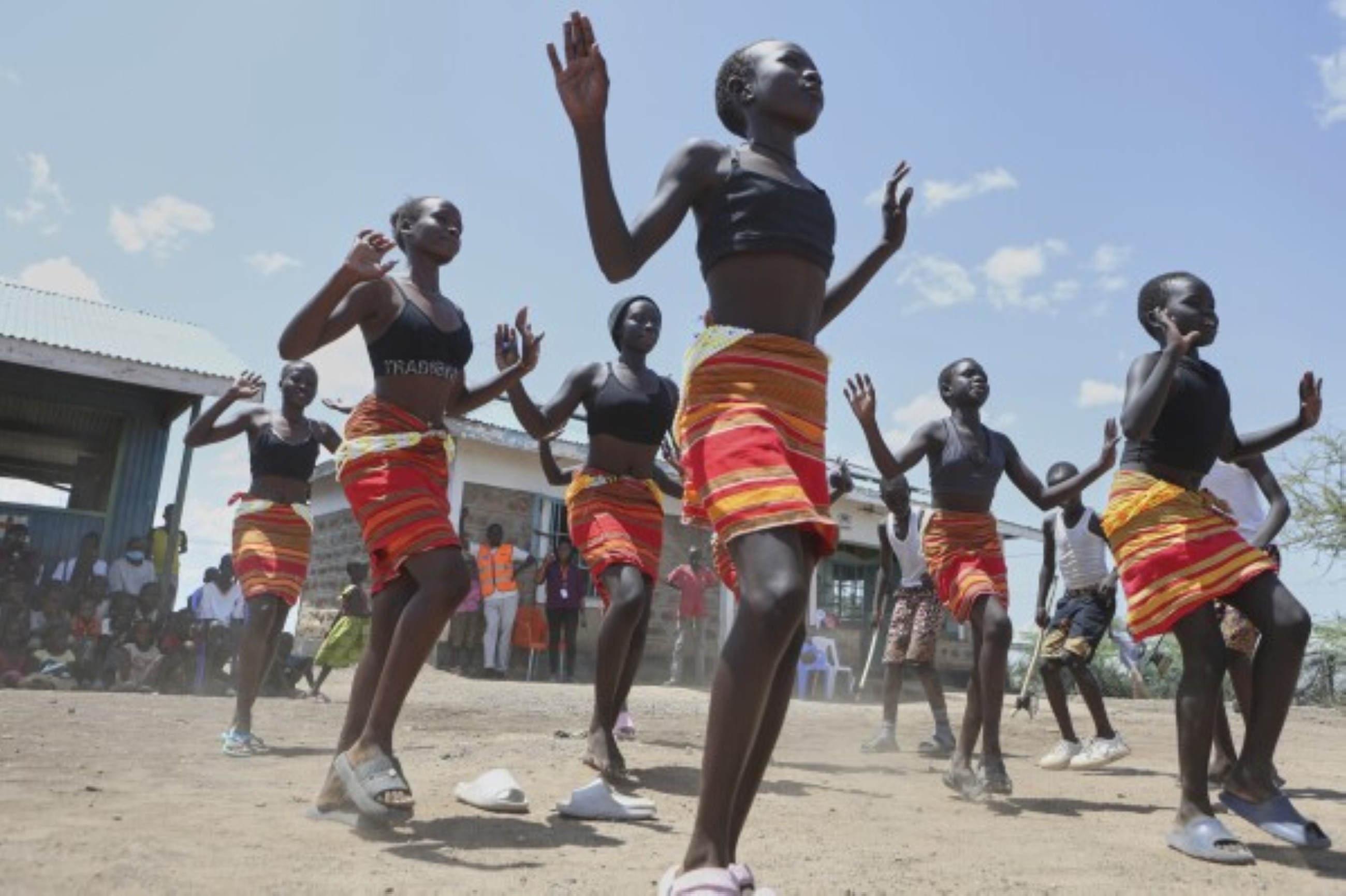 Fusion between culture and modernity as children dance in Kenyan refugee camp