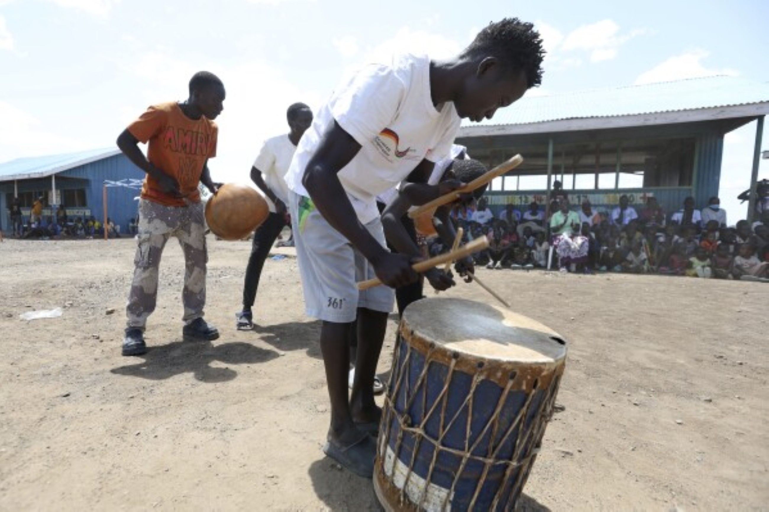 Fusion between culture and modernity as children dance in Kenyan refugee camp
