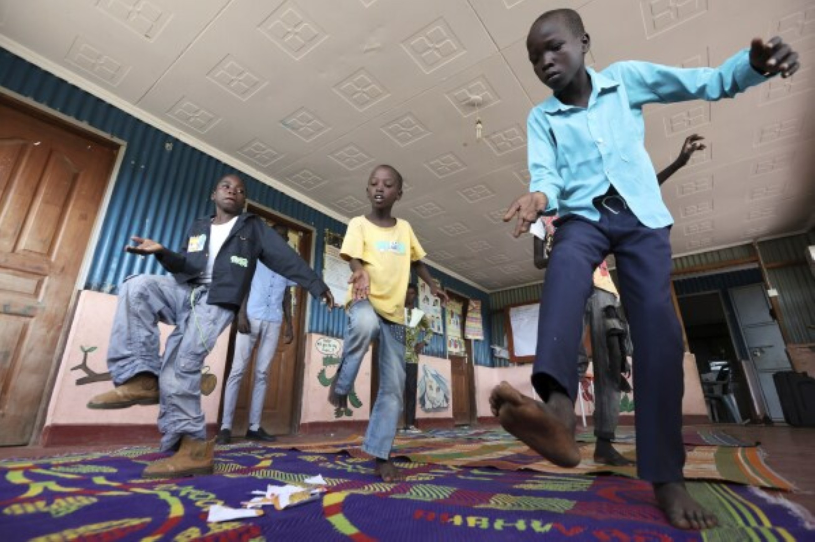 Fusion between culture and modernity as children dance in Kenyan refugee camp
