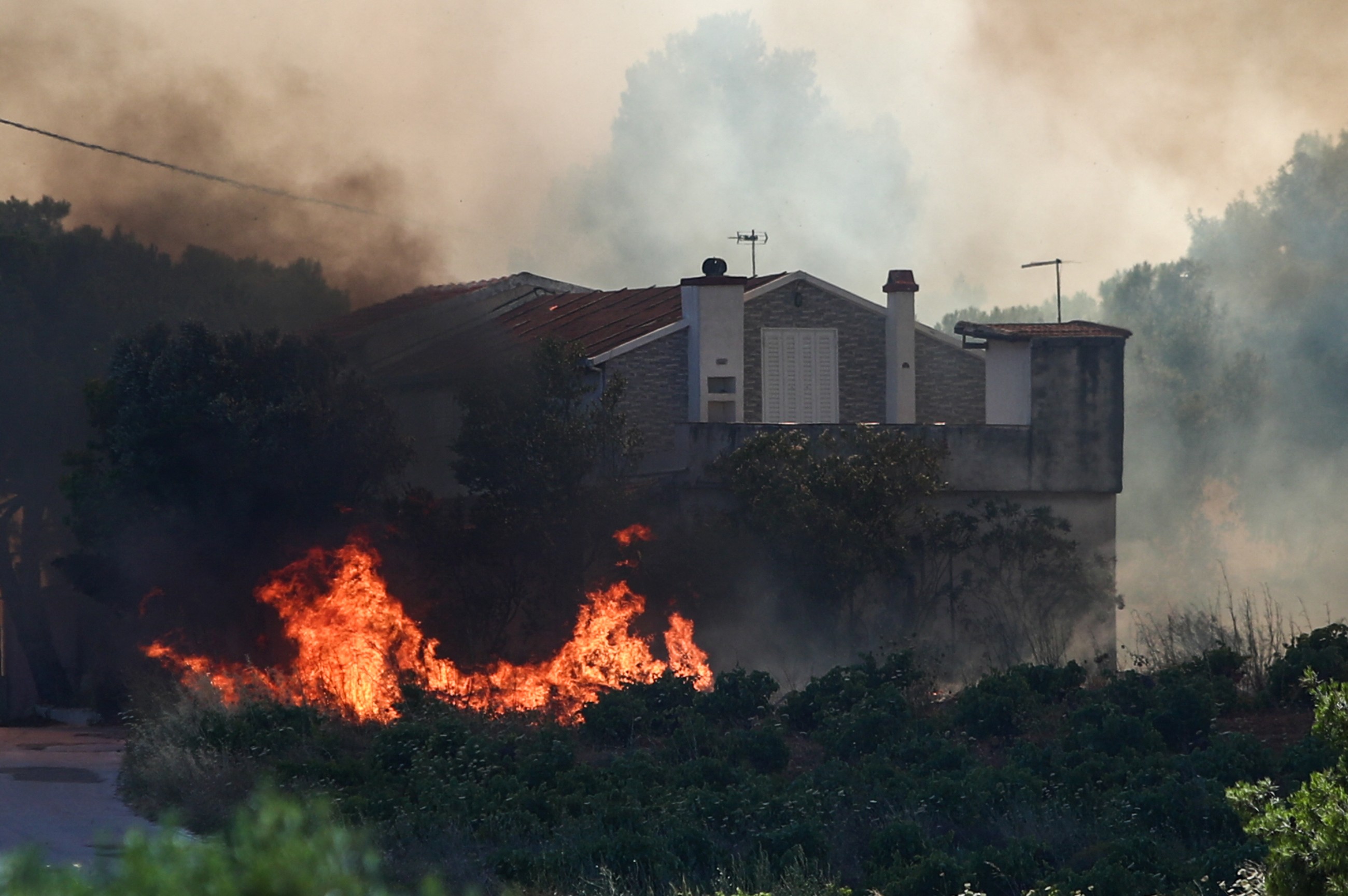 New fire threatens homes in Greece as Europe bakes in heatwave