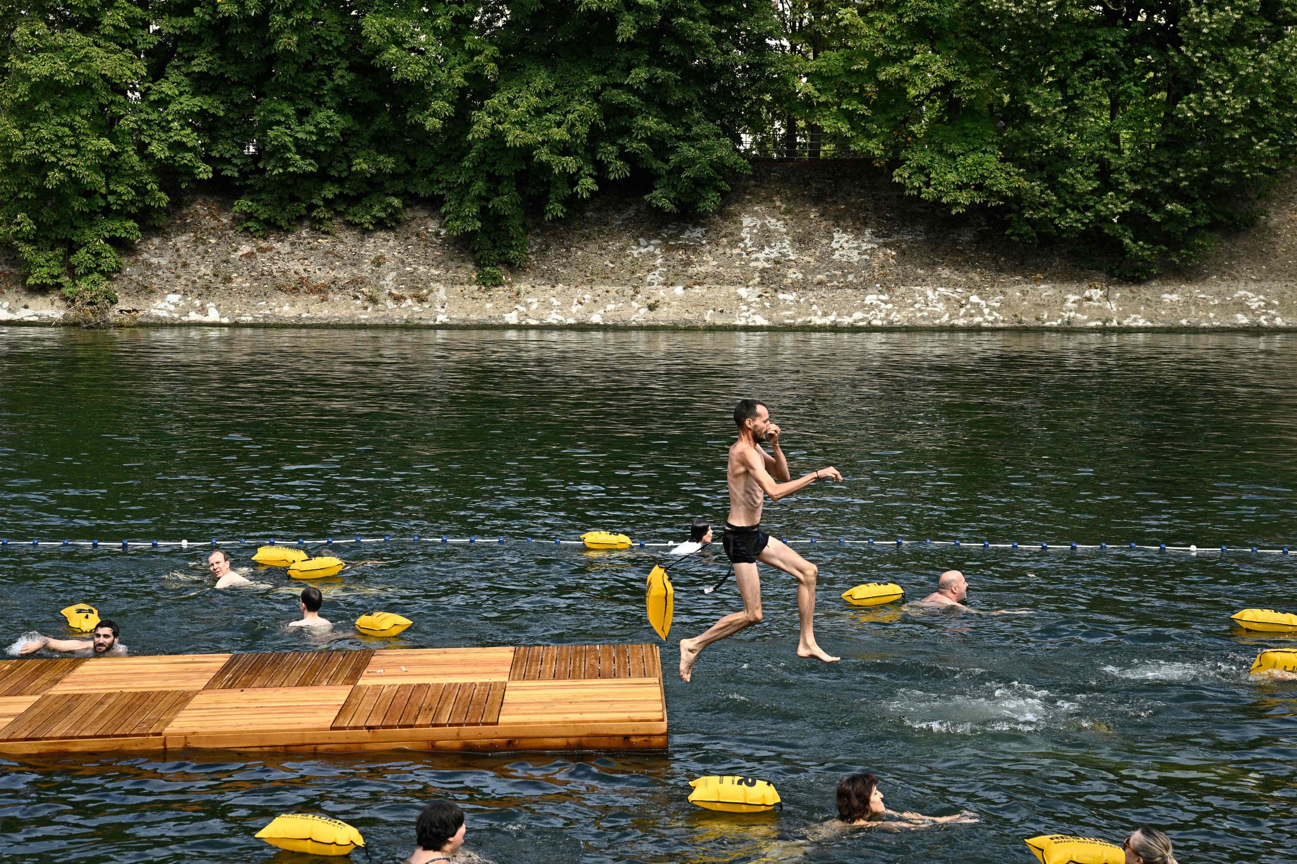 Happy swimmers cool off in Paris' Seine river after 100-year ban lifted